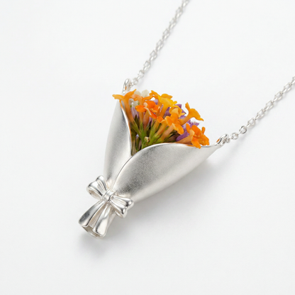 Silver necklace with a pendant featuring orange flowers on a white background