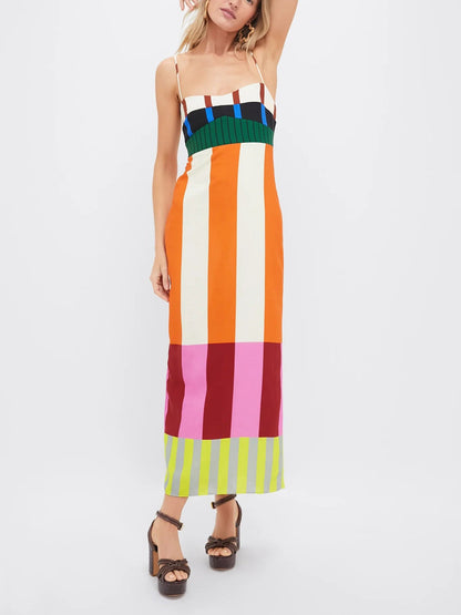 Woman wearing a colorful striped dress on a white background