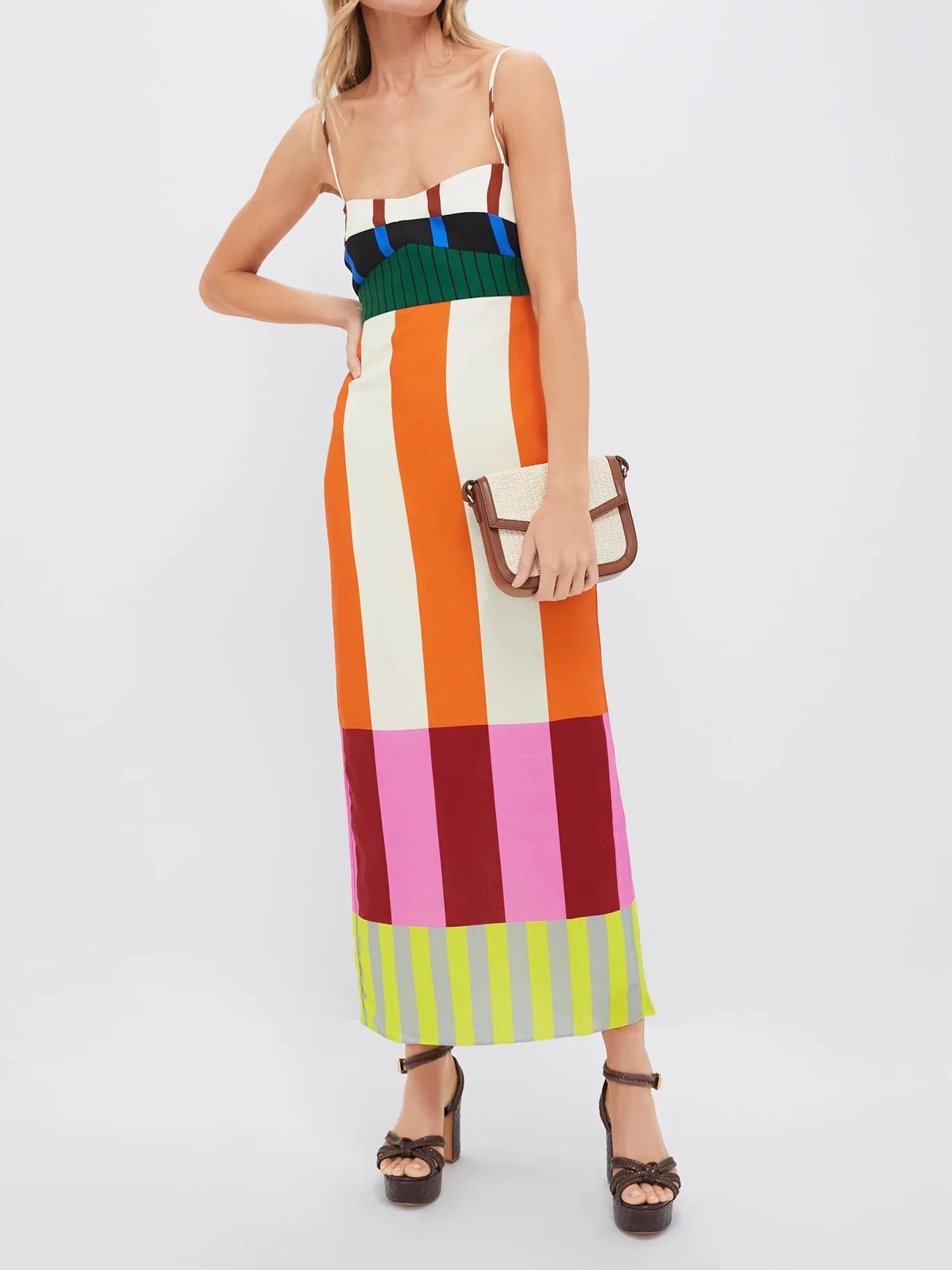 Woman wearing a colorful striped dress on a white background