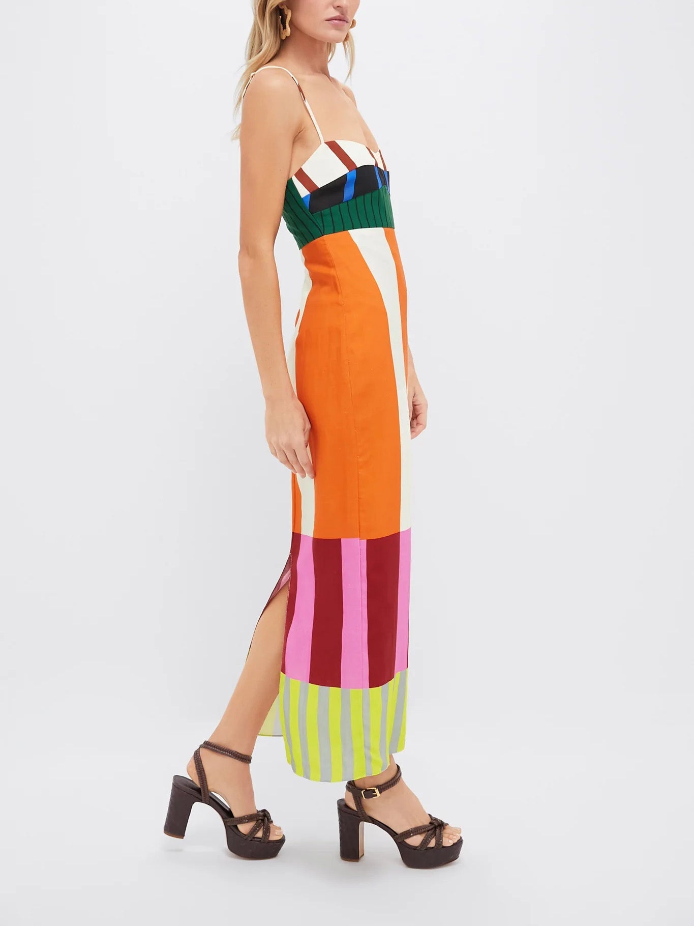 Woman wearing a colorful striped dress on a white background