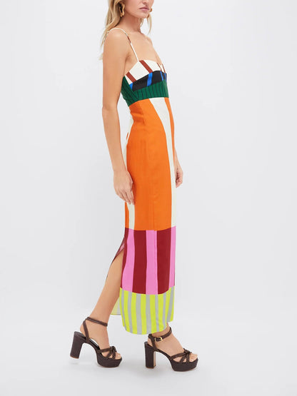 Woman wearing a colorful striped dress on a white background