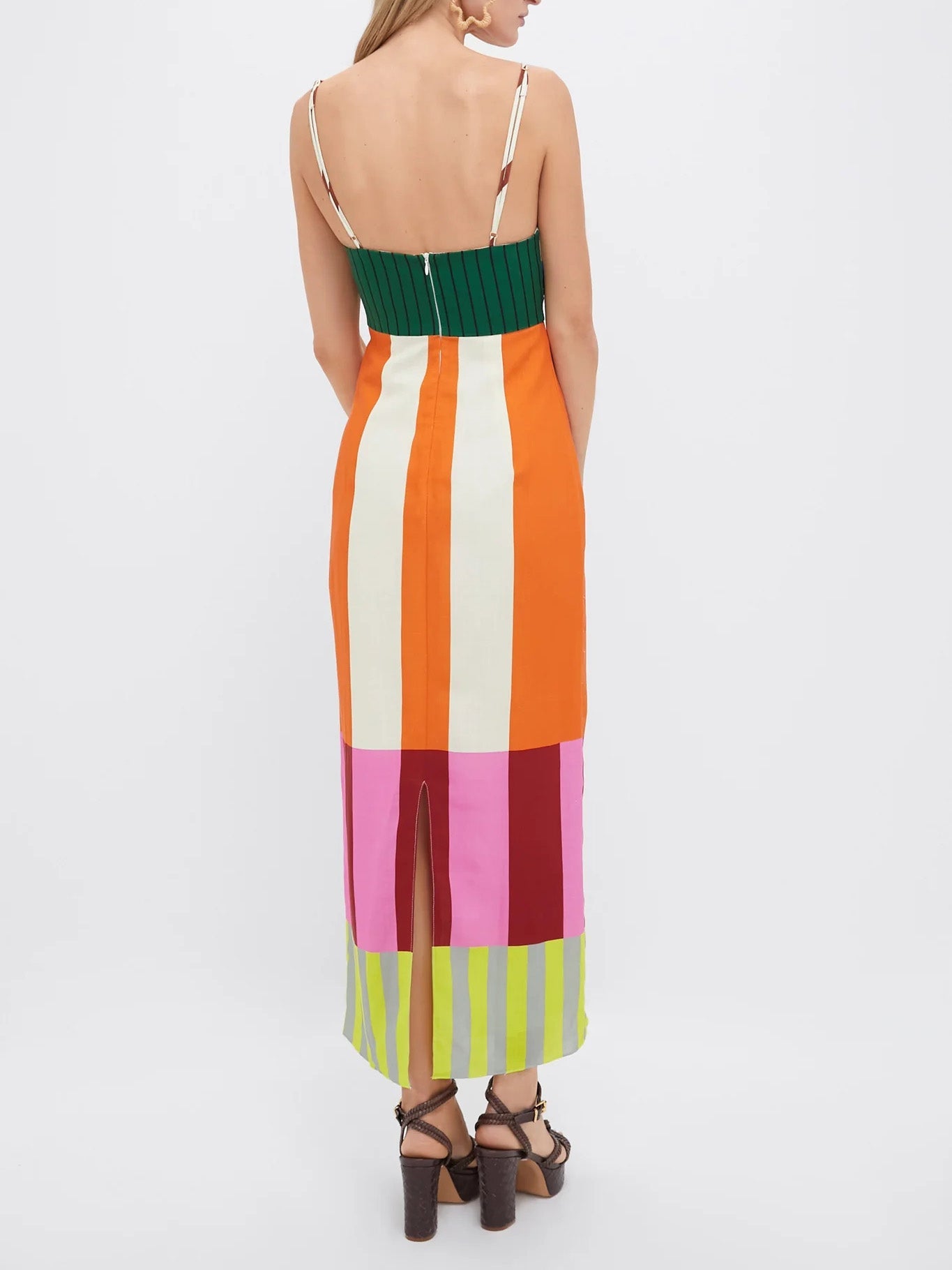 Multicolored striped dress with a green top and pink, red, and green bottom on a white background