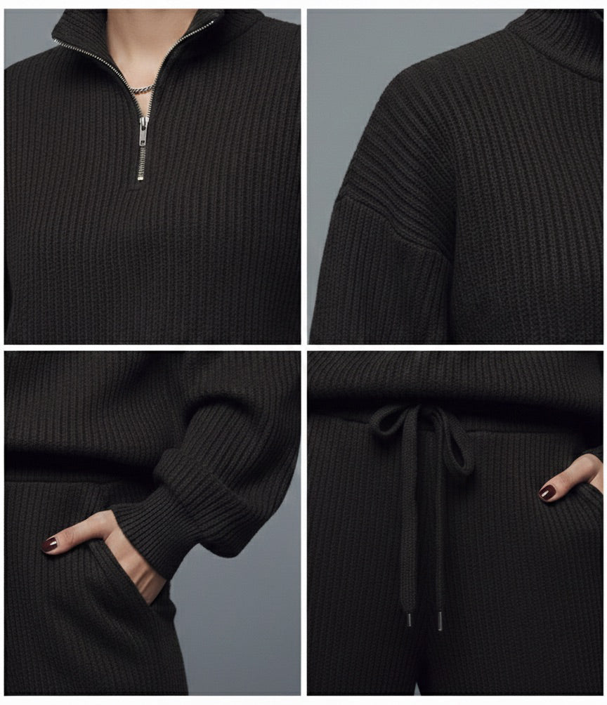 Black ribbed sweater with a quarter zip and drawstring pants on a gray background