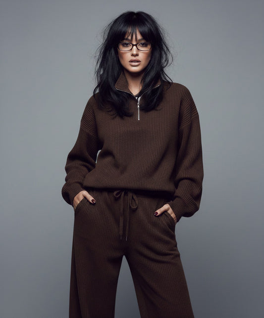 Person wearing a brown outfit against a gray background