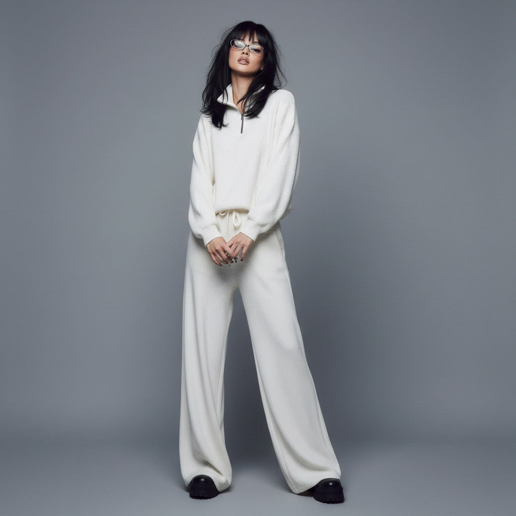 Person wearing a white outfit against a gray background