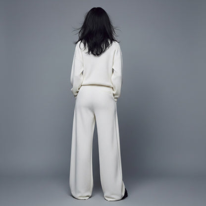 Person wearing a white outfit against a gray background