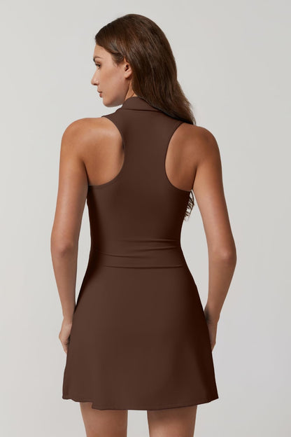 Woman wearing a brown dress against a plain background
