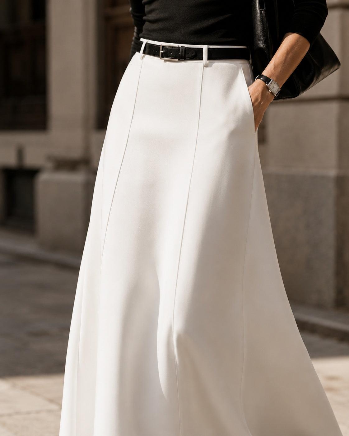 Close-up of the Alice Casual Midi Skirt showing waistband, vertical seams, pocket and smooth drape