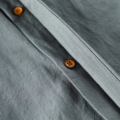 Close-up of a gray shirt with brown buttons