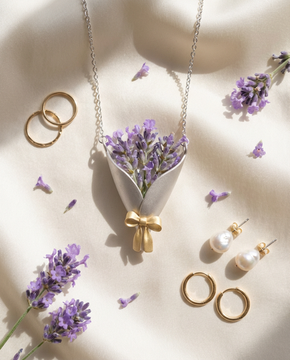 Jewelry set with necklace, earrings, and rings on a beige background with lavender flowers.