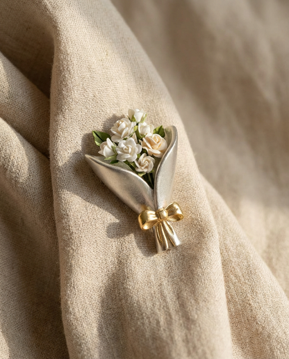 Floral brooch with gold bow on beige fabric