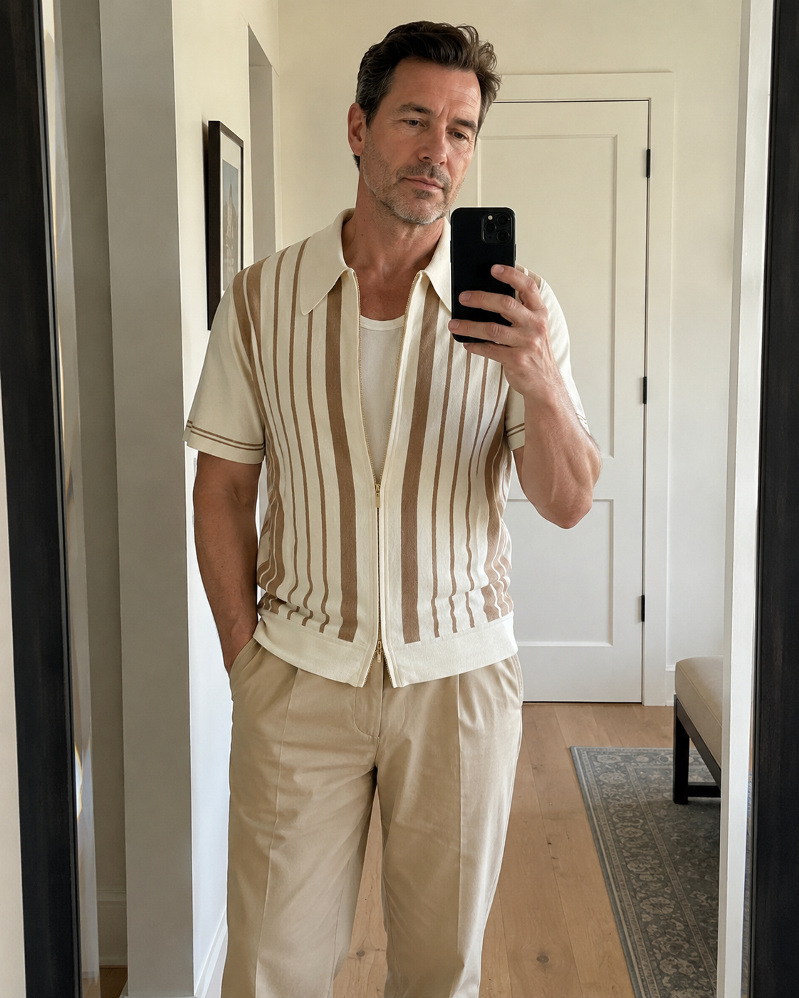 Mirror selfie style photo of a man over 40 wearing the Riviera striped cotton knit zip polo