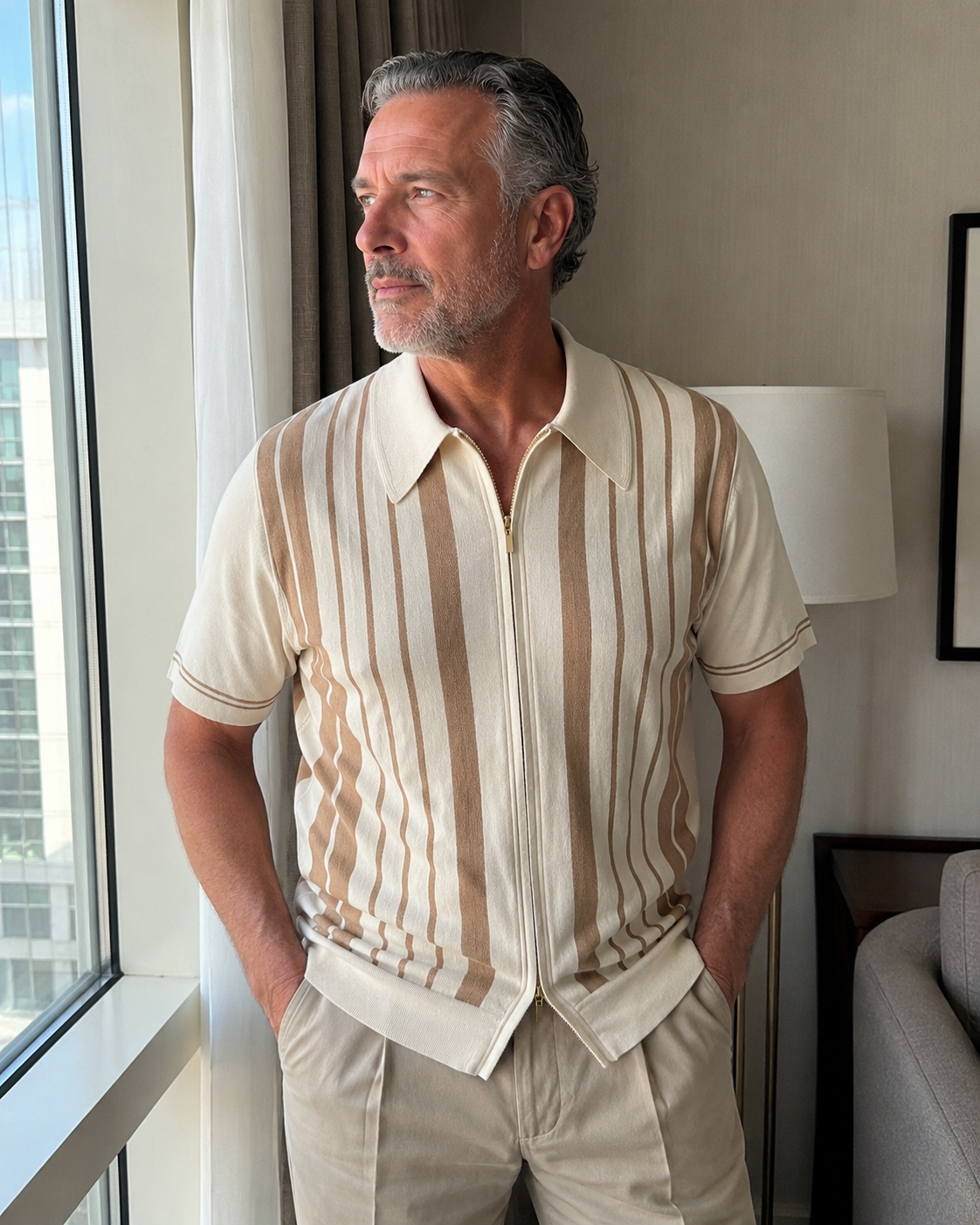 Window light style photo of a man over 40 wearing the Riviera striped knit zip polo