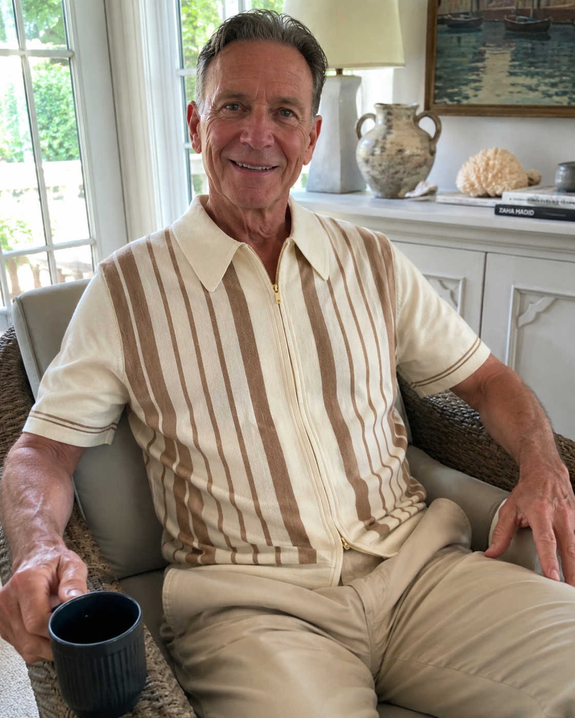 Sunroom style photo of a man over 40 wearing the Riviera striped cotton knit zip polo