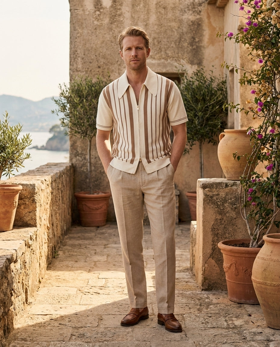 Man wearing Riviera cotton knit zip polo on a sunlit stone terrace
