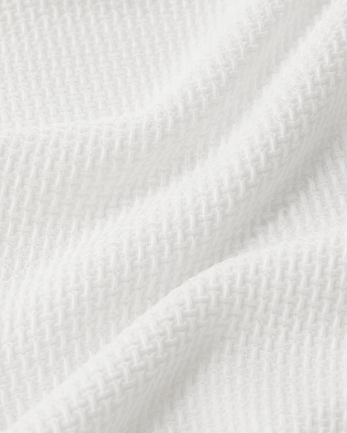 Macro close-up of the white Siena Weave Polo Shirt fabric texture