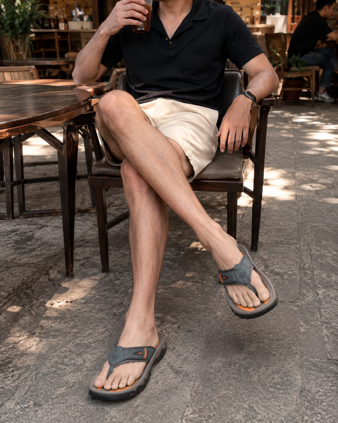 Café outfit reference wearing gray Sorrento Leather Sandals with black top and light shorts