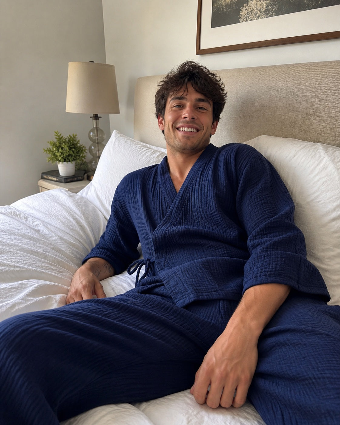 Man wearing the navy Yoake Kimono Set while relaxing in bed